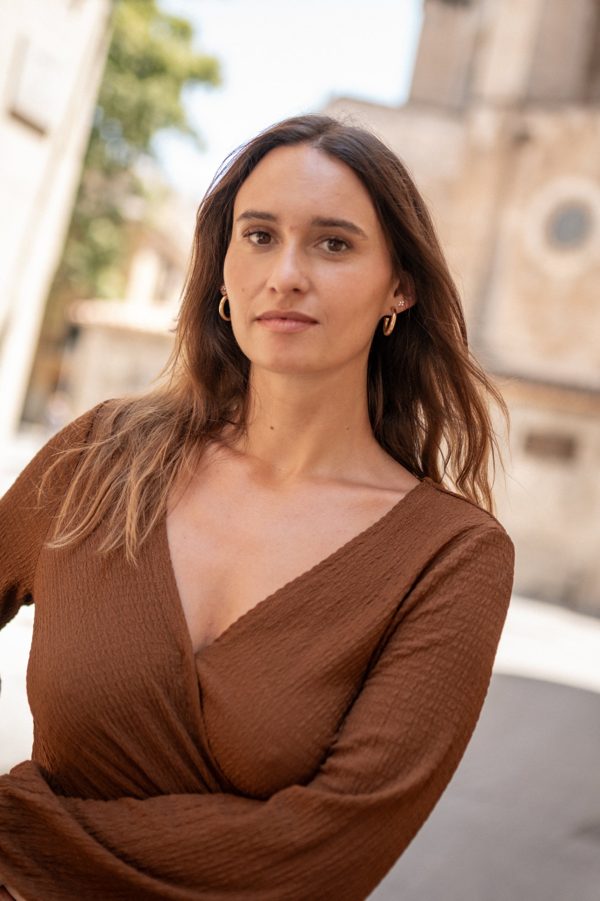 Woman wearing a brown dress with a blurred background