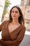 Woman wearing a brown dress with a blurred background